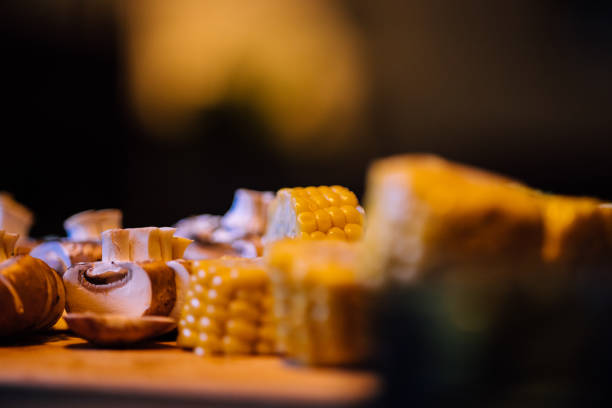 A closeup shot of corn and mushrooms on a blurred background