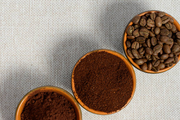istock coffee beans, ground coffee in cups on a linen background 1454986763