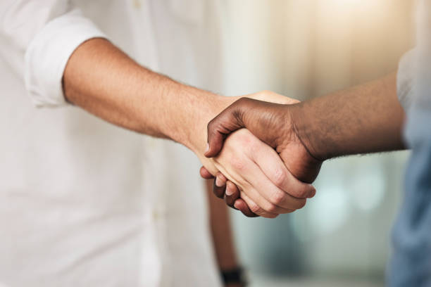 istock Business, handshake and partnership for deal, agreement or commitment in collaboration at the office. Hands of people shaking for meeting, b2b or greeting in teamwork, care and support at workplace 1454986833