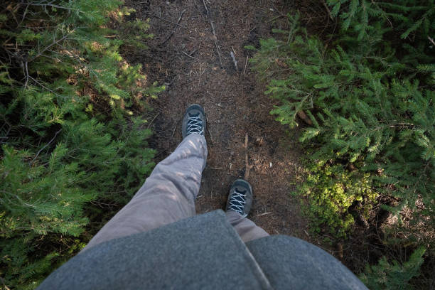 Low section of man hiking on a mountain footpath.
