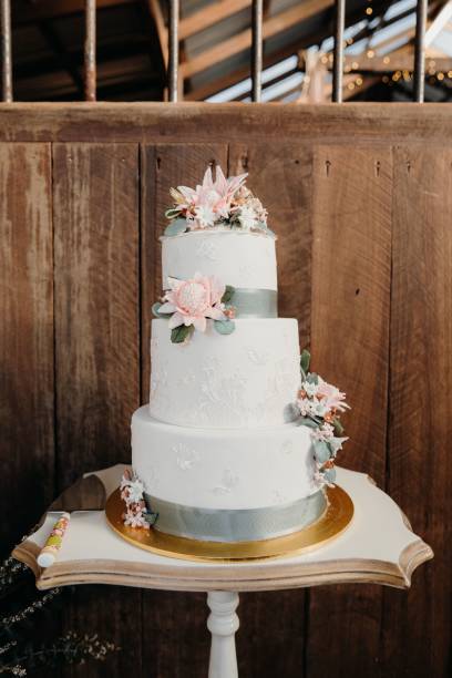 istock Vertical shot of a white cake against the brown wall 1454988104