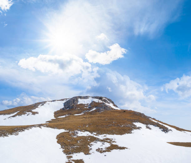 istock mountain ridge in snow at bright sunny day 1454988224