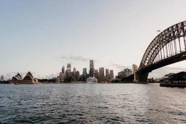 istock Long bridge over the river in a city 1454988613