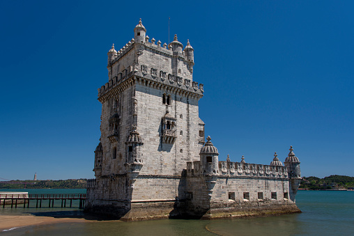 Torre de Belem in Lisbon under a clear blue sky.