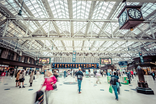 Glasgow, Scotland - July 14, 2022:  Passengers in a hurry to catch the train at  Glasgow Central station.