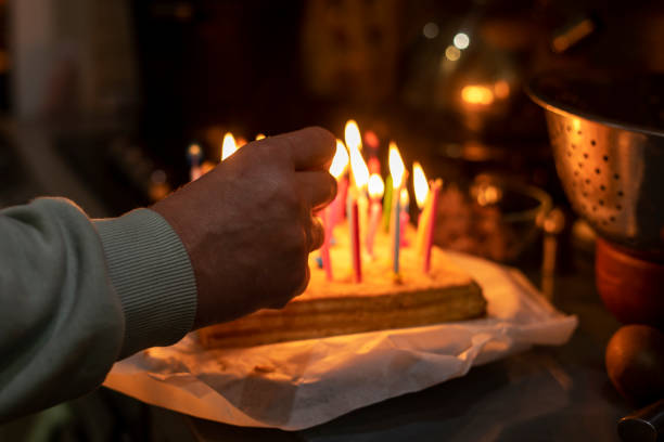 istock light candles on a birthday cake in the kitchen in the dark 1454989475