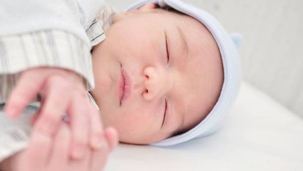istock Close-up of a beautiful sleeping baby on white 1454991027