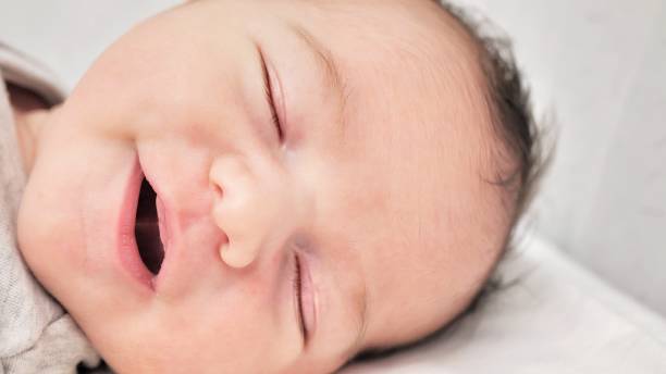istock Close-up of a beautiful sleeping baby on white 1454991036