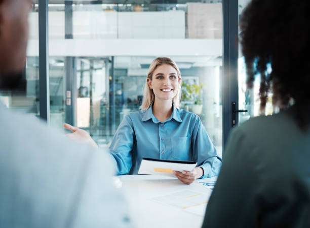 istock Woman, documents and meeting with client in office for planning, discussion or strategy for business. Business meeting, talking and smile at table with paper for collaboration, deal or contract 1454992524