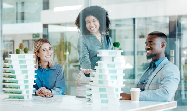 istock Architect, meeting and planning with a team at work in their office for design or building. Teamwork, model and collaboration with an architecture group working together on an engineer project 1454992536