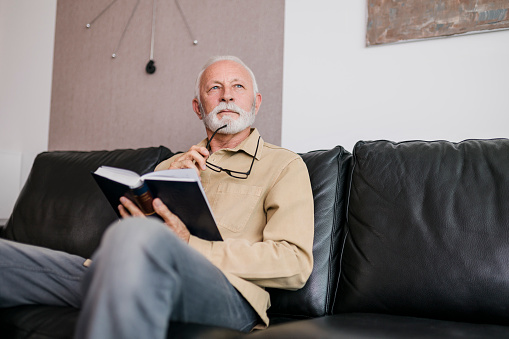 Senior Man reading book at home