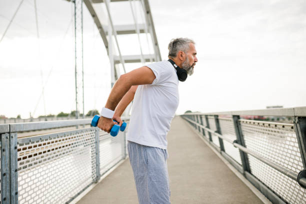 istock Senior man having outdoor training with weights 1454993711