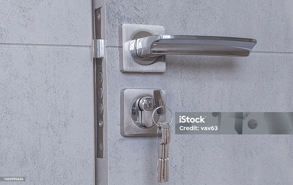 Door lock Door lock with rotary handle and keys installed in a wooden door Apartment Stock Photo