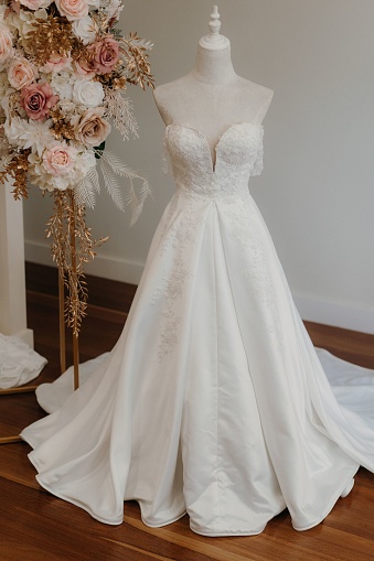 A white elegant wedding dress on a mannequin