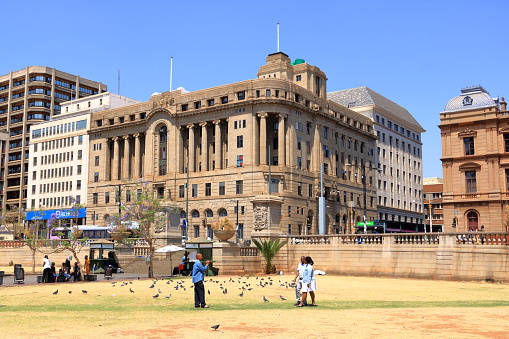 September 29 2022 - Pretoria in South Africa: Church Square, People during the day, walking or resting on the grass in the center of the City