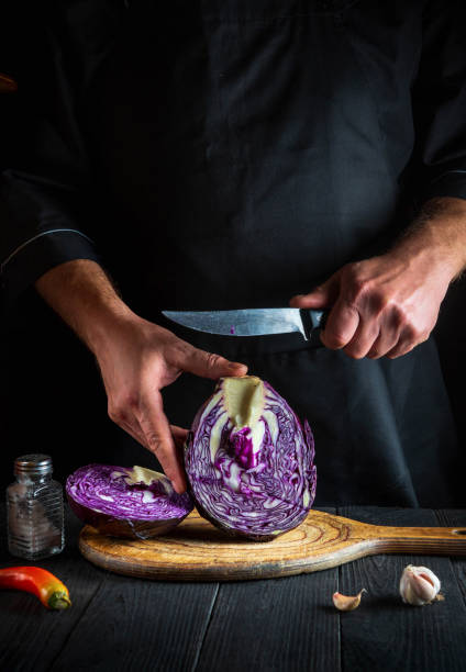 istock A professional chef cuts red cabbage with a knife. Cooking vegetable salad in the restaurant kitchen. Vegetable diet idea. 1454996336