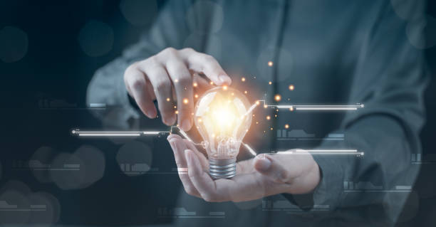 istock Hand with a light bulb. The idea of inspiration from online technology. innovation idea concept. 
Success business solution, creative and brainstorm symbol by glowing light. Knowledge aspiration. 1454996420