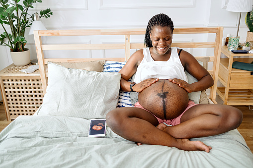 Pregnant woman caressing her belly