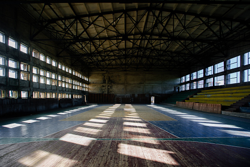Large old ruined gymnasium in abandoned school.