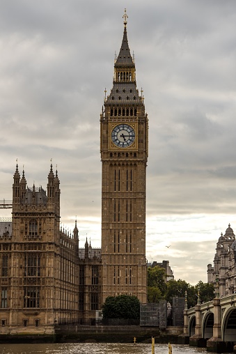 A vertical shot of Big Ben and the Houses of Parliament near Westminster Bridge in London, England