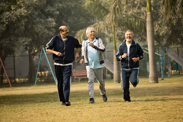 istock Cheerful old men friends running at park 1454999882