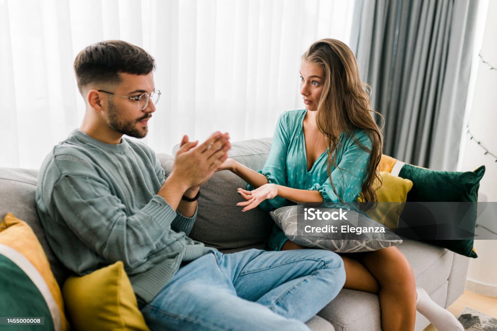 Shot of a young couple having an argument at home Men Stock Photo