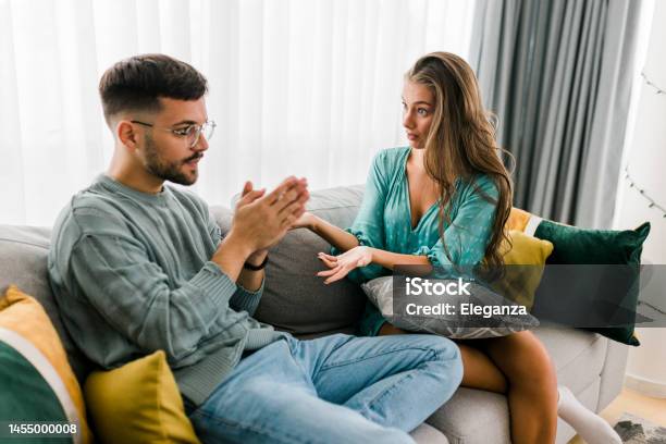Shot Of A Young Couple Having An Argument At Home Stock Photo - Download Image Now - Men, Women, Couple - Relationship