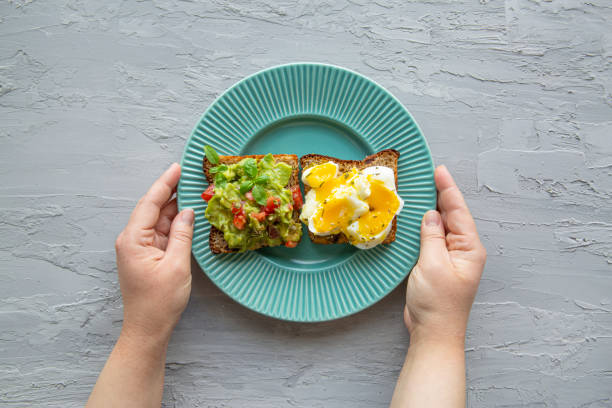 istock Healthy snack concept. Sandwiches with avocado and eggs, top view. 1455001099