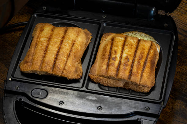 istock croque monsieur cooking in a sandwich maker 1455003102