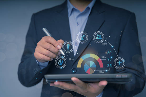 istock Businessman using tablet to navigate user interface UX UI futuristic graphic icon design with people outline communication and planning innovation concept teamwork strategic planning modern technology 1455006548