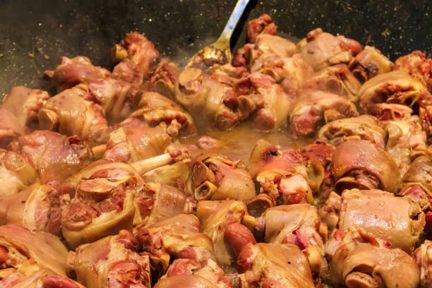 cooking of pork knuckle (traditional german dish) in big cauldron - shank sauerkraut german cuisine pork imagens e fotografias de stock