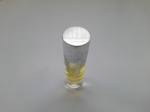 A refreshing pint of cold beer on a wood surface with white background.