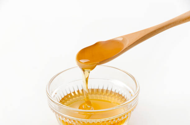 istock fresh honey flowing on spoon in a bowl 1455010298