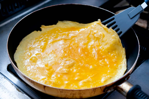 istock Egg Omelette Cooking in a Frying Pan 1455010374