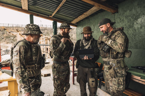 istock Group of soldiers discussing something before combat 1455010620