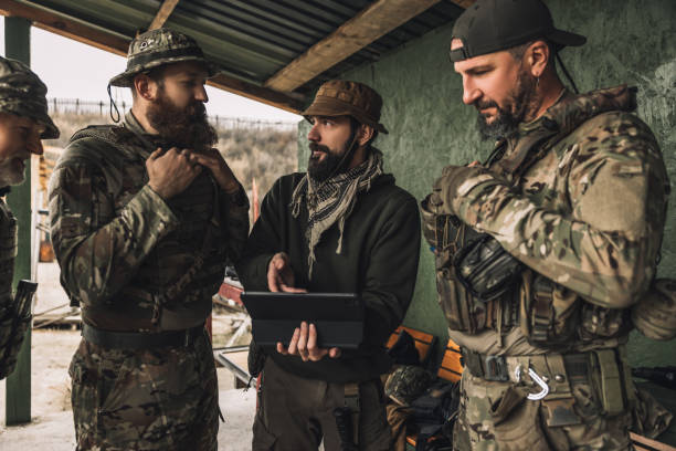 istock Group of soldiers discussing something before combat 1455010625