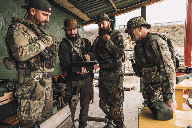 istock Group of soldiers discussing something before combat 1455010628