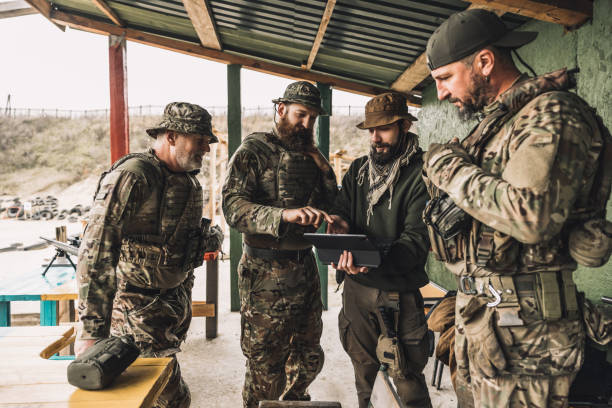istock Group of soldiers discussing something before combat 1455010637