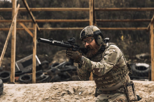 istock Soldier in camouflage with a rifle in hands 1455010687