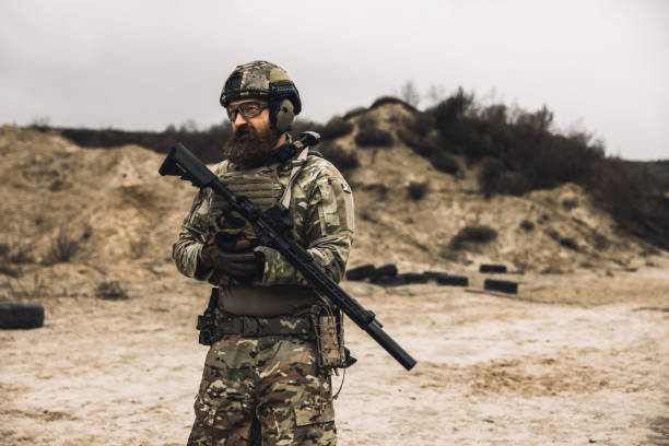 istock A man in military uniform with a rifle 1455010744