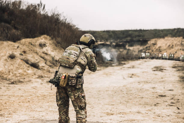 istock A man in military uniform with a rifle 1455010745