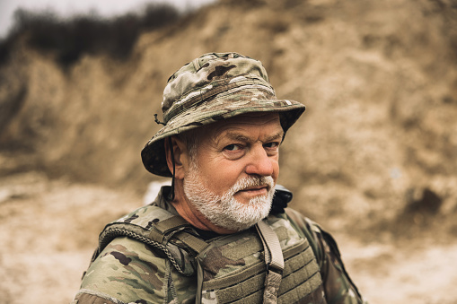 On a shooting range. Mature bearded soldier on a shooting range