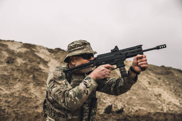 istock Soldier with a rifle on a shooting range 1455010826