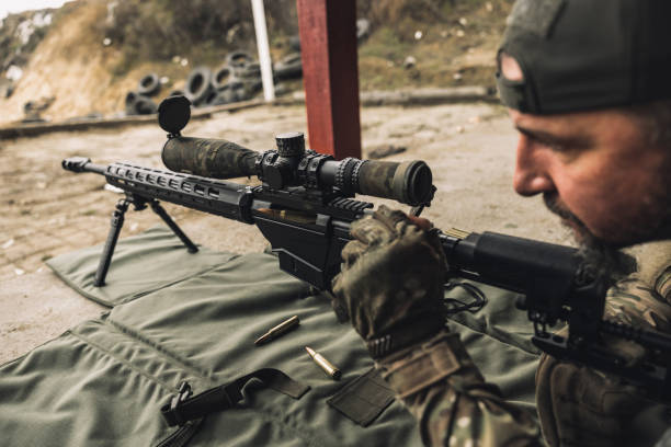 istock Soldier with rifle bfor shooting the target 1455010900