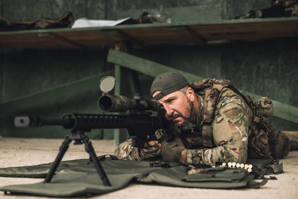 istock Soldier with rifle bfor shooting the target 1455010905