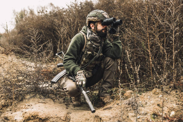 istock Soldier with binocular investigating the place 1455010908