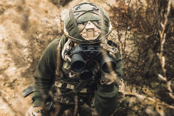 istock Soldier with binocular investigating the place 1455010911
