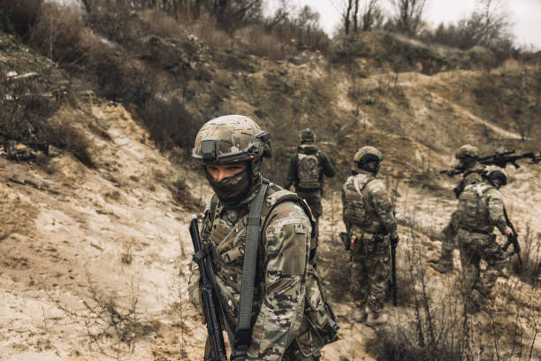 istock Group of soldiers on a shooting range 1455010985