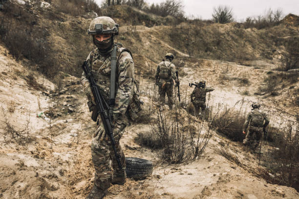 istock Group of soldiers on a shooting range 1455010987