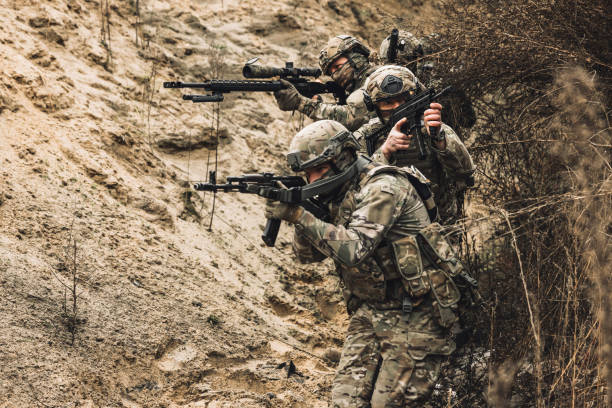 istock Group of soldiers with rifles before combat 1455011000